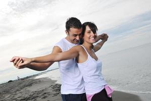 happy young couple have fun at beautiful beach photo