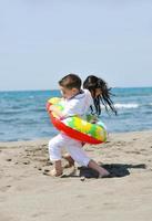 happy young  people group have fun on beach photo