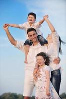 familia joven feliz divertirse en la playa foto