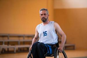 a photo of a war veteran playing basketball with a team in a modern sports arena. The concept of sport for people with disabilities