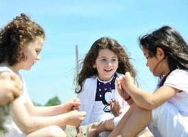 happy child group playing  on beach photo