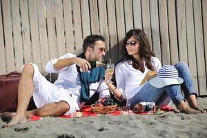 young couple enjoying  picnic on the beach photo