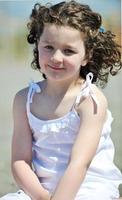 happy child group playing  on beach photo