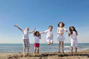 happy young  people group have fun on beach photo