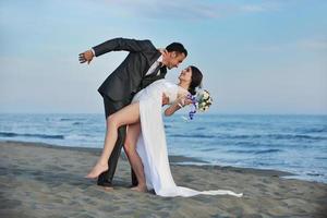 romantic beach wedding at sunset photo