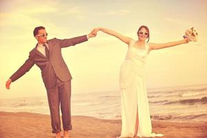 romantic beach wedding at sunset photo