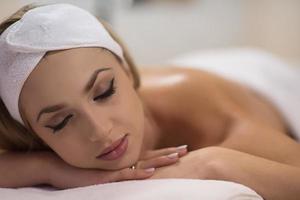 woman laying on massage table photo