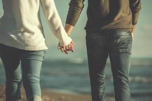 Loving young couple on a beach at autumn sunny day photo