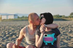 happy young couple have fun on beach photo