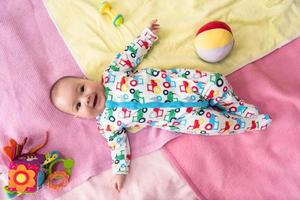 top view of newborn baby boy lying on colorful blankets photo