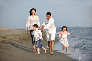 happy young family have fun on beach photo