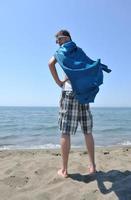 funny superhero standing on beach photo