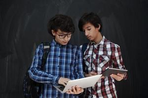 Arab teenagers group working on laptop and tablet computer photo