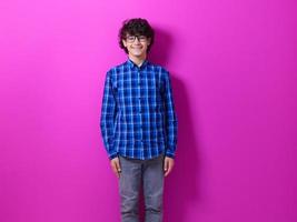 portrait  of smart looking arab teenager  against pink background photo