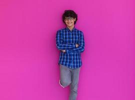 retrato de un adolescente árabe de aspecto inteligente contra un fondo rosa foto