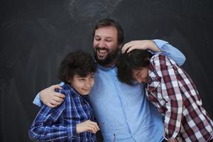 happy father hugging sons photo