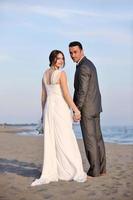 romantic beach wedding at sunset photo