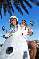 retrato de feliz pareja de amor joven en scooter disfrutando del verano foto