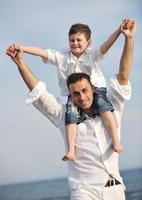 happy father and son have fun and enjoy time on beach photo