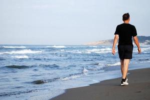 man running on beach photo