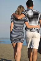 couple on beach with travel bag photo