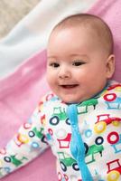 top view of newborn baby boy lying on colorful blankets photo