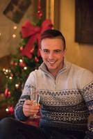 Happy young man with a glass of champagne photo