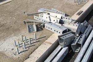 Installing a new road railing infrastructure. Steel crosspieces laying highway equipment. Construction of tracks for cars. Development and improvement of transport junction. Erection overpass in city photo