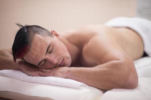 handsome man resting in a spa massage center photo