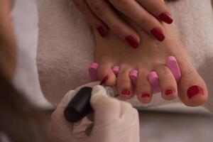 female feet and hands at spa salon photo