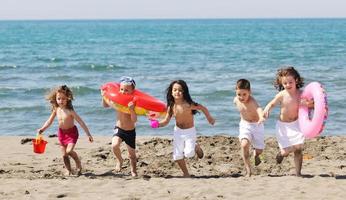 child group have fun and play with beach toys photo