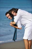 happy young couple have fun at beautiful beach photo