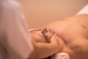 man receiving a head massage photo