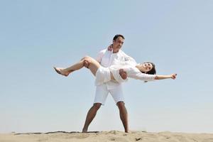 happy young couple have fun on beach photo