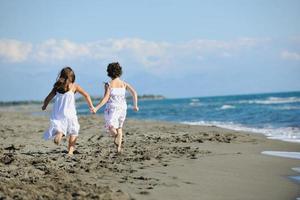 cute little girls running on beach photo