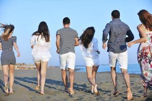 happy young  people group have fun on beach photo