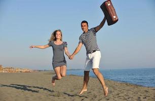 couple on beach with travel bag photo