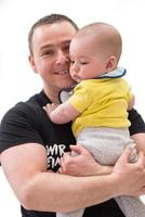 portrait of happy young father holding baby isolated on white photo