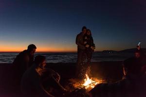 Friends having fun at beach on autumn day photo