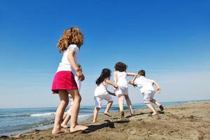 happy young  people group have fun on beach photo