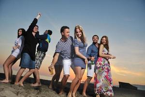 Group of young people enjoy summer  party at the beach photo