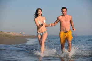 happy young couple have fun on beach photo