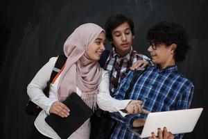 Arab teenagers group working on laptop and tablet computer photo