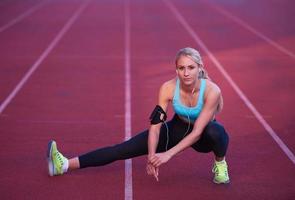 sporty woman on athletic race track photo