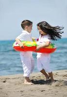 happy child group playing  on beach photo