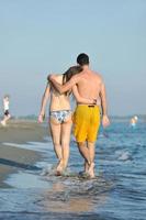 happy young couple have fun on beach photo