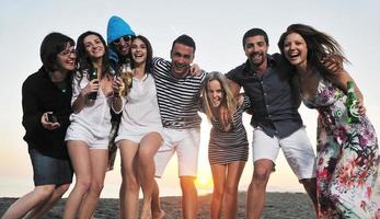 Group of young people enjoy summer  party at the beach photo