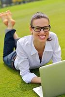 woman with laptop in park photo