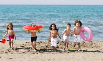 child group have fun and play with beach toys photo