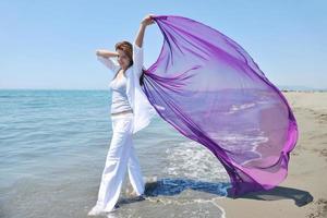 beautiful young woman on beach with scarf photo